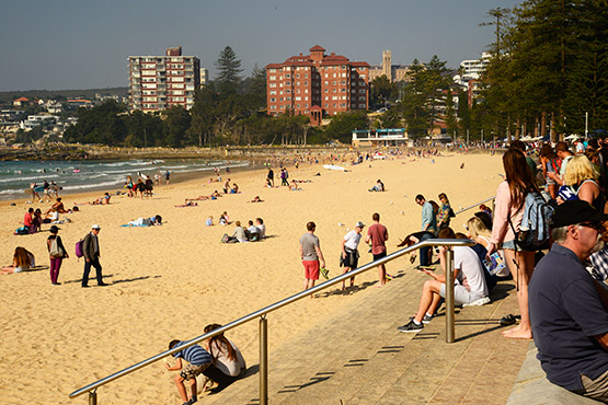 Beach-goers look for a spot to set up at Manly Beach, Sydney